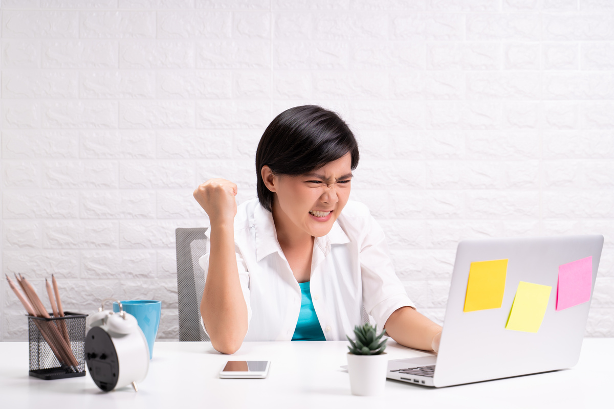 Angry woman working at office